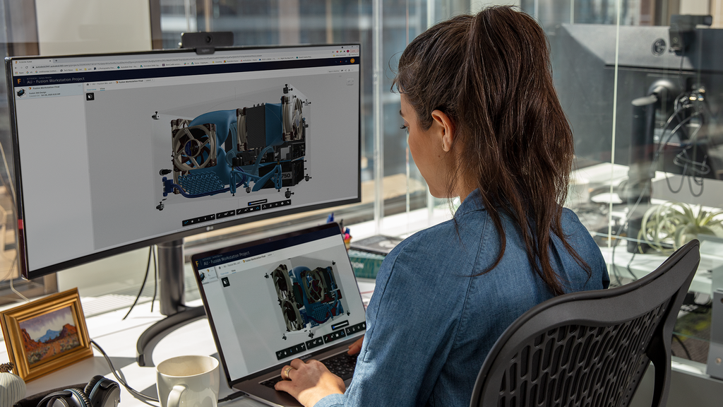 Woman using Autodesk APS on dual screens in office