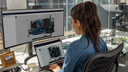 Woman using Autodesk APS on dual screens in office