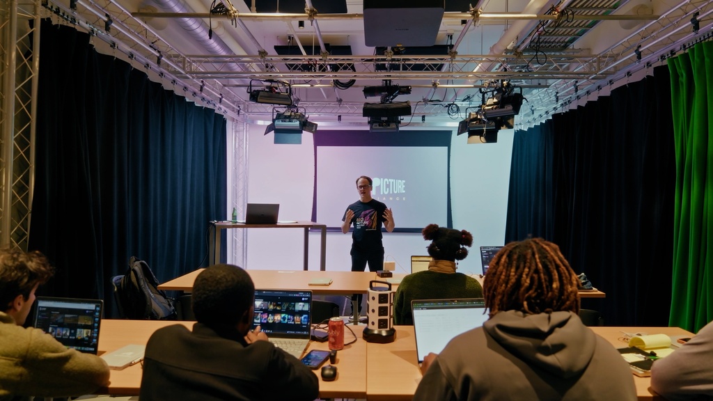 Instructor presenting to students in tech studio
